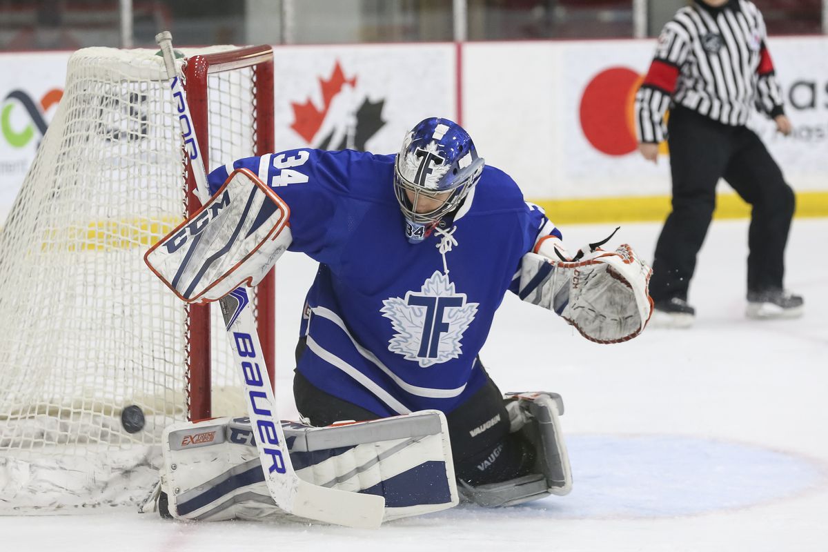 Amanda Makela, wearing home blues, makes a save in a 2017-18 game against the Calgary Inferno.