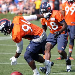 Broncos OLD DeMarcus Ware tips the ball for OLB Shaquil Barrett in the loose ball sideline drill