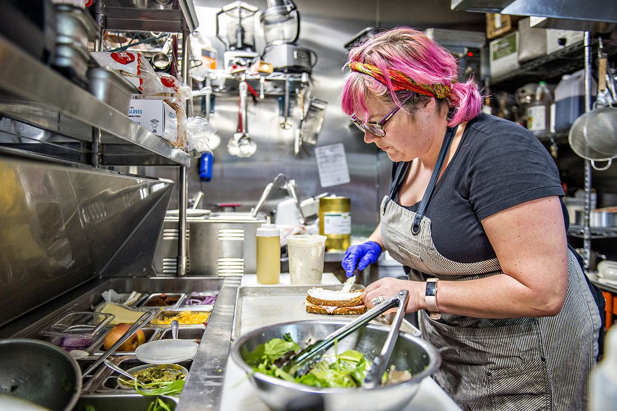 Chef Diana Presson Eller working on lunch orders in the kitchen.