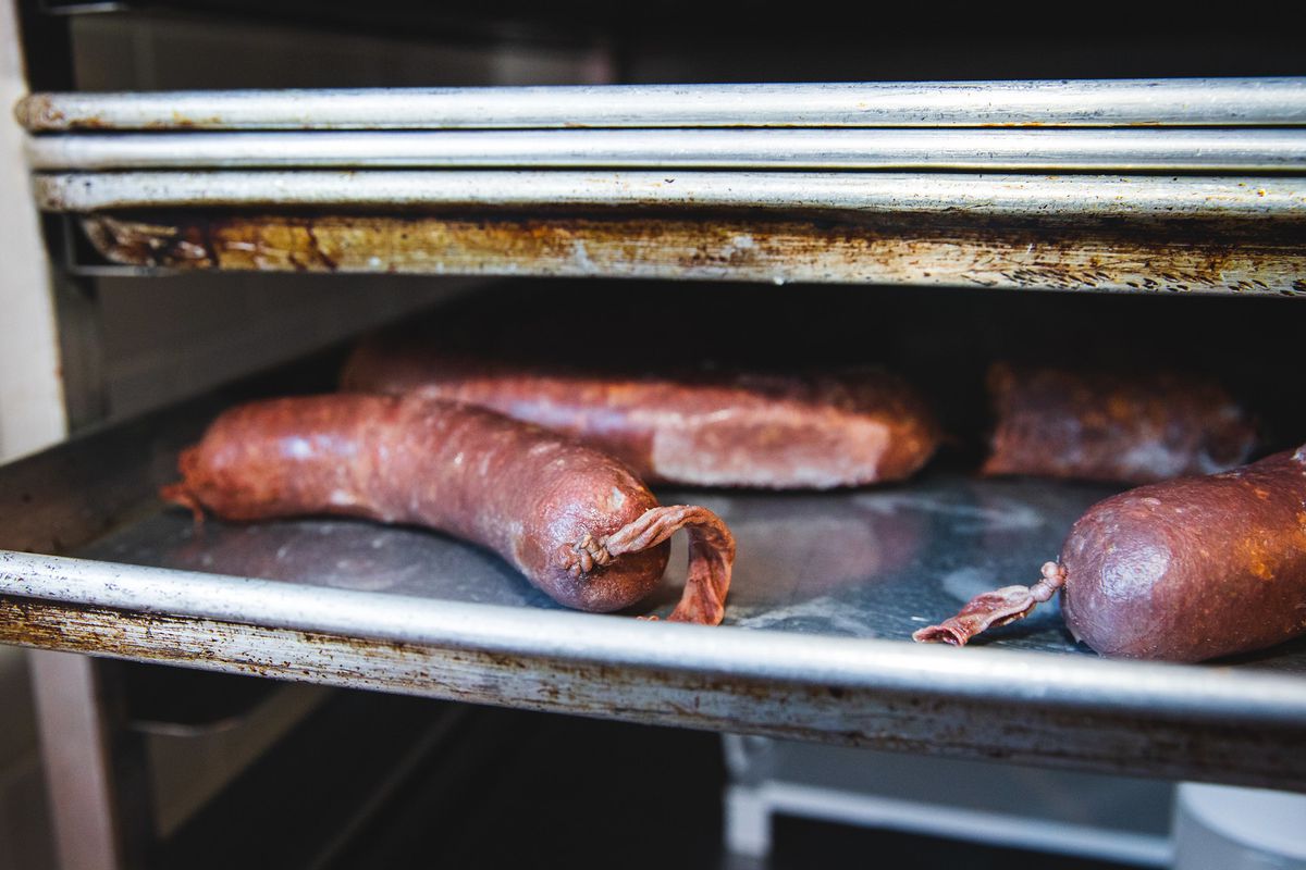 Encased meats on a metal tray.