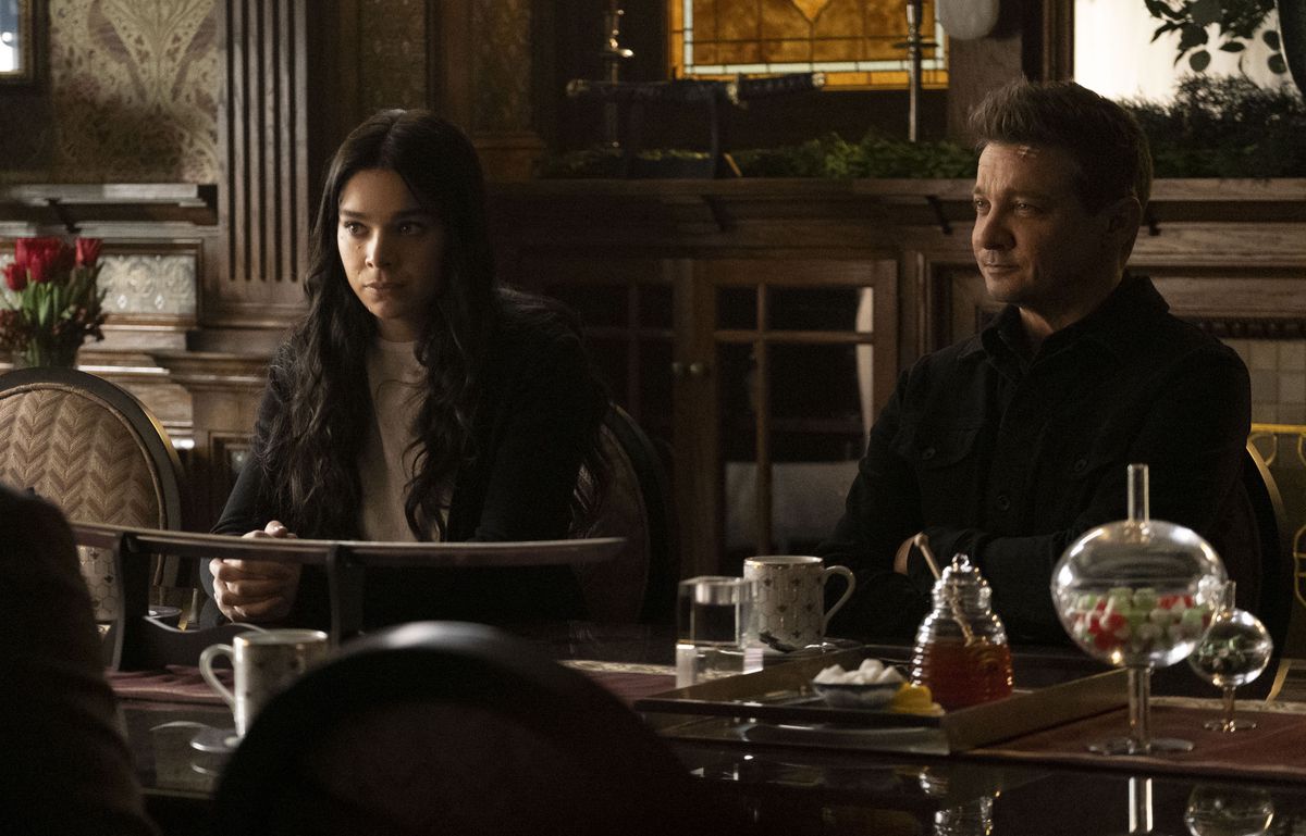 Hailee Steinfeld and Jeremy Renner sit next to each other in Hawkeye
