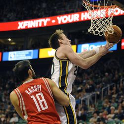 Utah Jazz shooting guard Gordon Hayward (20) goes to the basket past Houston Rockets small forward Omri Casspi (18) during a game at EnergySolutions Arena on Monday, Dec. 2, 2013.