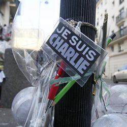 Flowers are laid near the headquarters of magazine Charlie Hebdo in Paris, Friday Feb. 6, 2015. Brothers Said and Cherif Kouachi killed 12 people in a terror attack at the offices of French satirical publication Charlie Hebdo on Jan. 7. The two gunmen, were killed by French police two days later. 