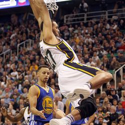 Utah Jazz center Rudy Gobert reaches for a slam dunk in the first half of an NBA regular season game against the Golden State Warriors at the Vivint Arena in Salt Lake City, Wednesday, March 30, 2016.