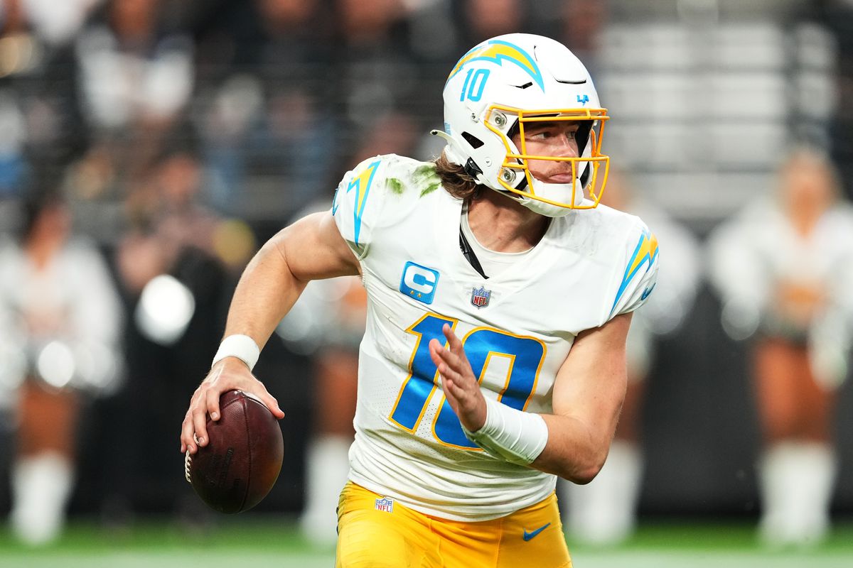 LAS VEGAS, NEVADA - DECEMBER 04: Justin Herbert #10 of the Los Angeles Chargers runs with the ball in the second half of a game against the Las Vegas Raiders at Allegiant Stadium on December 04, 2022 in Las Vegas, Nevada.