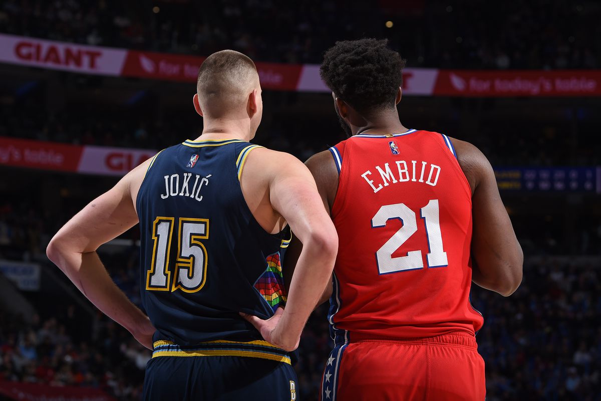 Nikola Jokic #15 of the Denver Nuggets talks with Joel Embiid #21 of the Philadelphia 76ers during the game on March 14, 2022 at the Wells Fargo Center in Philadelphia, Pennsylvania