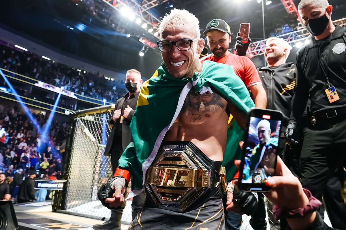 Charles Oliveira of Brazil celebrates after defeating Dustin Poirier to defend his lightweight title during the UFC 269 event at T-Mobile Arena on December 11, 2021 in Las Vegas, Nevada.