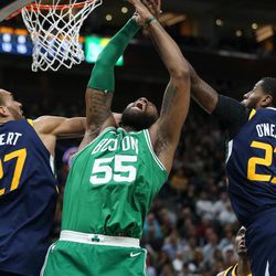 Boston Celtics center Greg Monroe (55) tries to pull in rebound between Utah Jazz center Rudy Gobert (27) and forward Royce O'Neale (23) at Vivint Smart Home Arena in Salt Lake City on Wednesday, March 28, 2018.