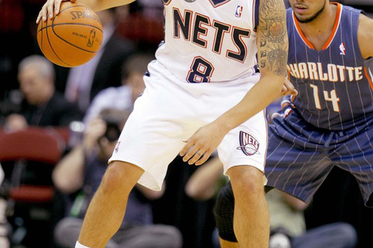 Mar 24, 2012; Newark, NJ, USA;  New Jersey Nets point guard Deron Williams (8) works against Charlotte Bobcats point guard D.J. Augustin (14) during the first half at the Prudential Center. Mandatory Credit: Jim O'Connor-US PRESSWIRE