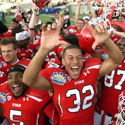 Utah's Chaz Walker, center, celebrates with teammates after an overtime victory over Georgia Tech in the Sun Bowl NCAA college football game on Saturday, Dec. 31, 2011, in El Paso, Texas. (AP Photo/El Paso Times, Victor Calzada)