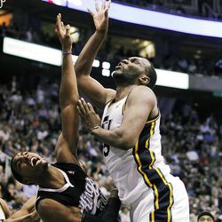 Utah Jazz center Al Jefferson, right, slams into Sacramento Kings forward Jason Thompson, left, as he goes to the basket during the second half of their NBA basketball game in Salt Lake City, Friday, March 30, 2012. The Kings won 104-103. (AP Photo/Steve C. Wilson)