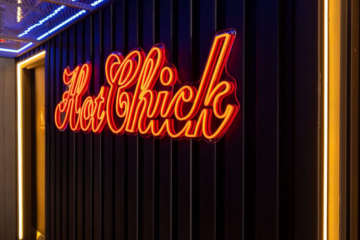 A neon sign that says “Hot Chick”