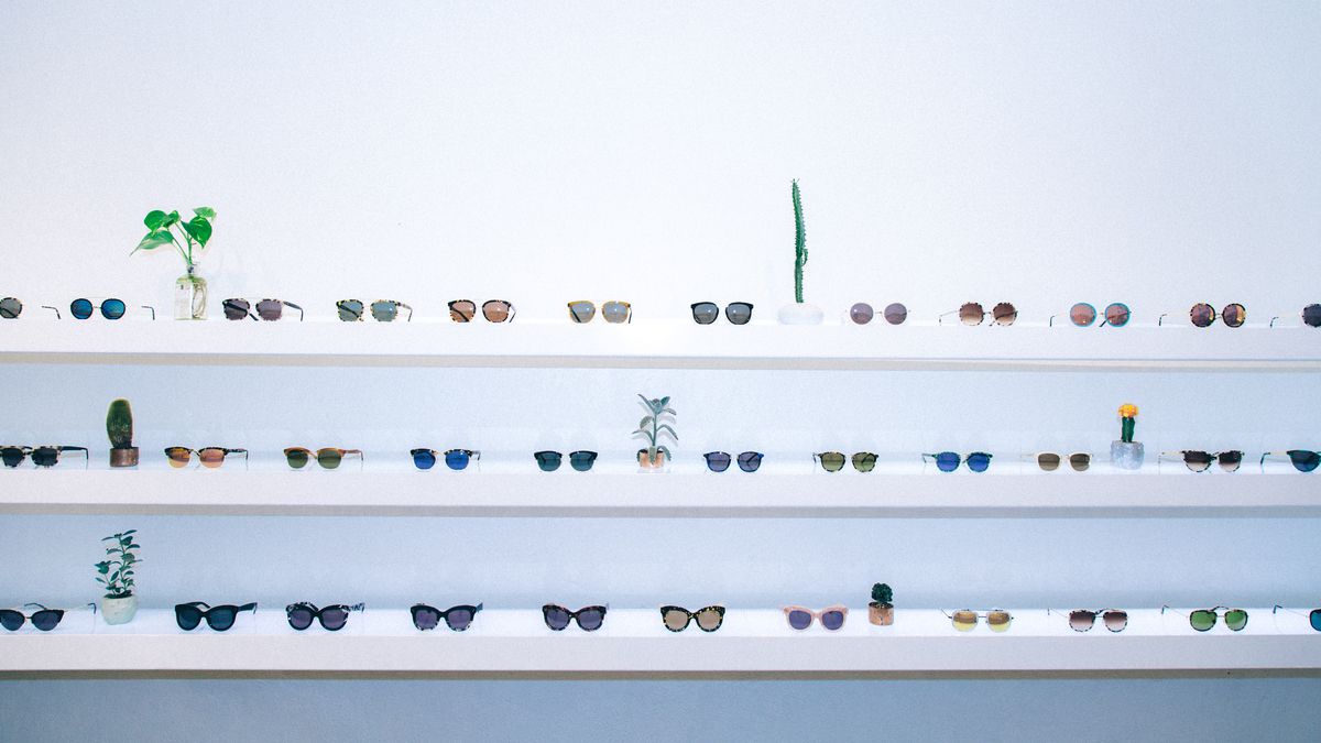 A wall displaying Krewe du Optic sunglasses. 