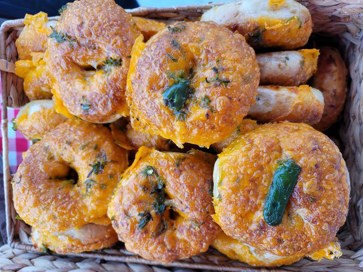 A basket of cheddar cheese and jalapeno bagels at a farmers market in Atlanta from the Bronx Bagel Buggy.