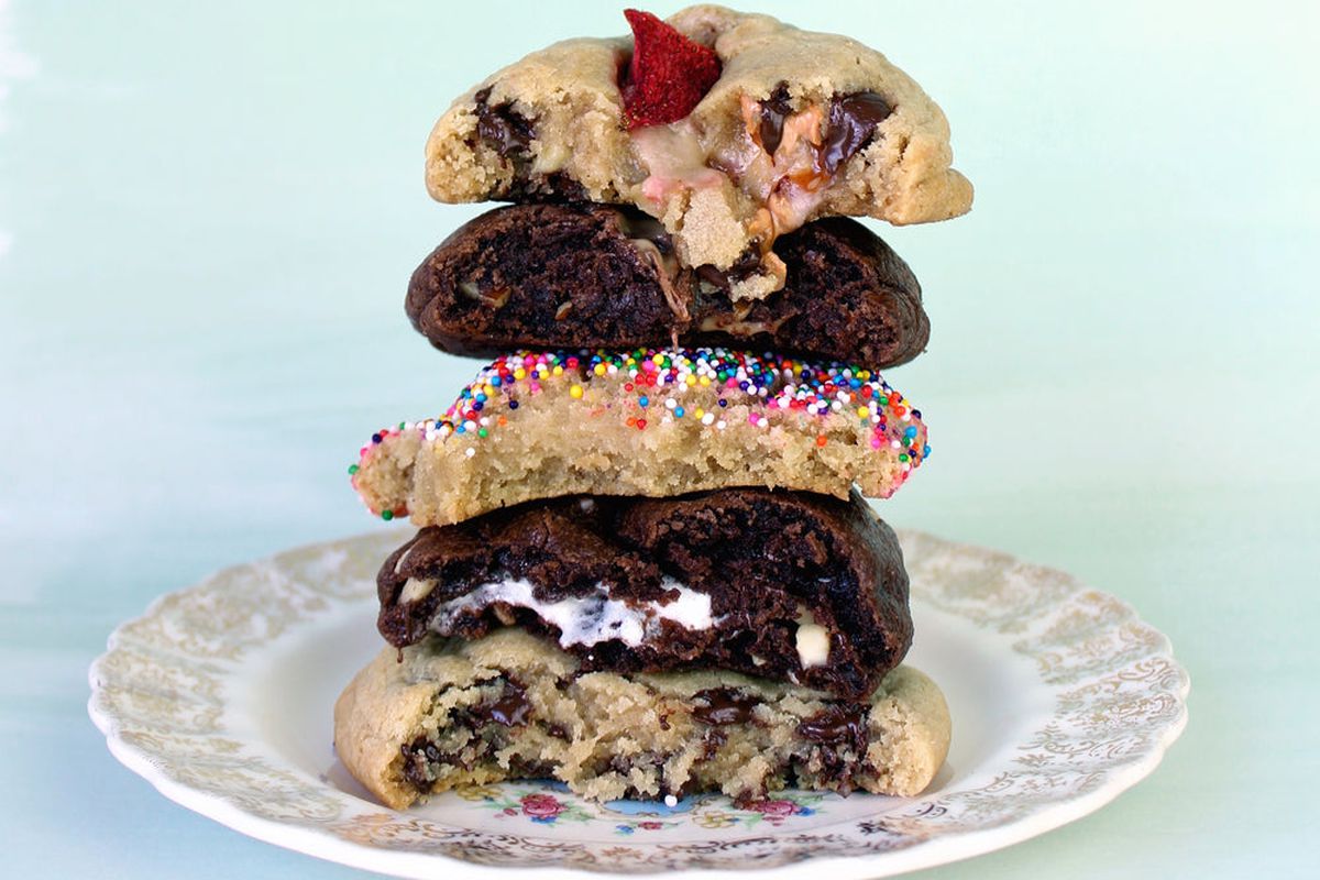 A colorful stack of half-eaten cookies on an ornate plate.