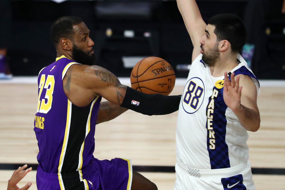 LeBron James of the Los Angeles Lakers drives to the basket against Goga Bitadze #88 of the Indiana Pacers during the second quarter in a NBA basketball game at the ESPN Wide World Of Sports Complex on August 8, 2020 in Lake Buena Vista, Florida.