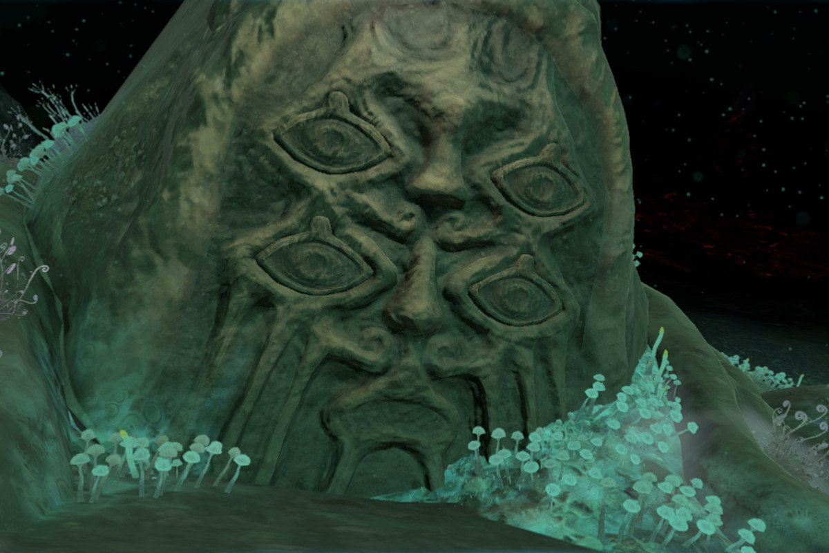 The face of a bargainer statue in Tears of the Kingdom, which has several eyes and a pointy hood-shaped head. Moss and glowing green flora grows around the base of the ominous statue.