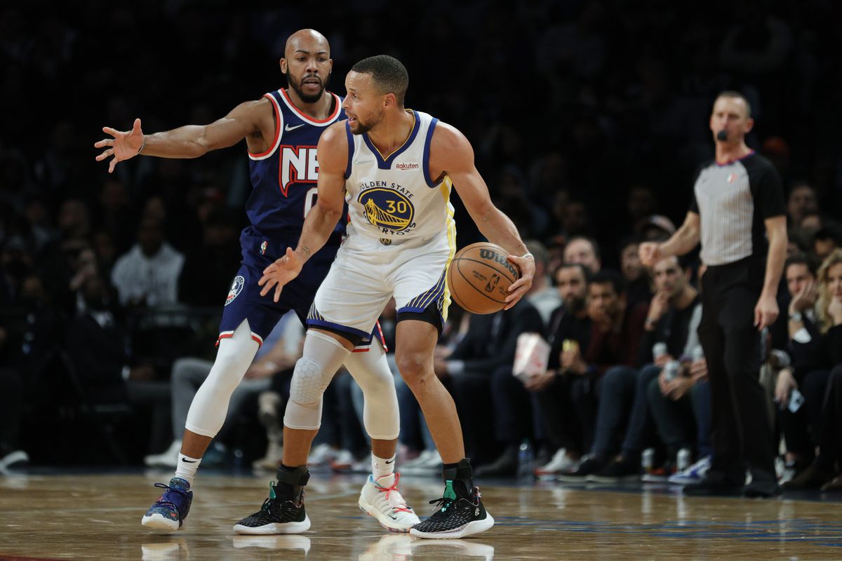 Stephen Curry #30 of the Golden State Warriors dribbles against Jevon Carter #0 of the Brooklyn Nets during the first half at Barclays Center on November 16, 2021 in the Brooklyn borough of New York City.&nbsp;