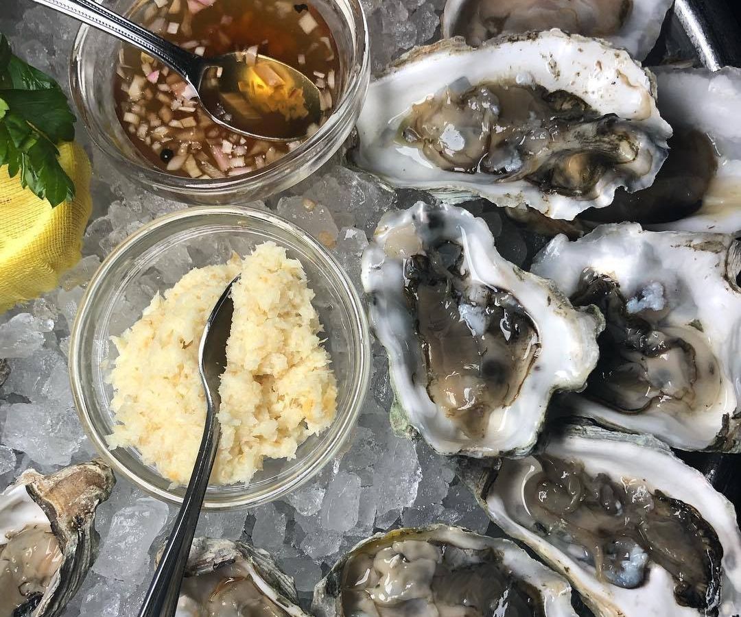 A bunch of oysters on an ice platter.
