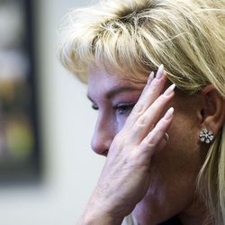 Lone Peak High School Principal Rhonda Bromley wipes a tear away in her office Dec. 6 while talking about her experience of receiving a call about a suicide committed by one of her students.