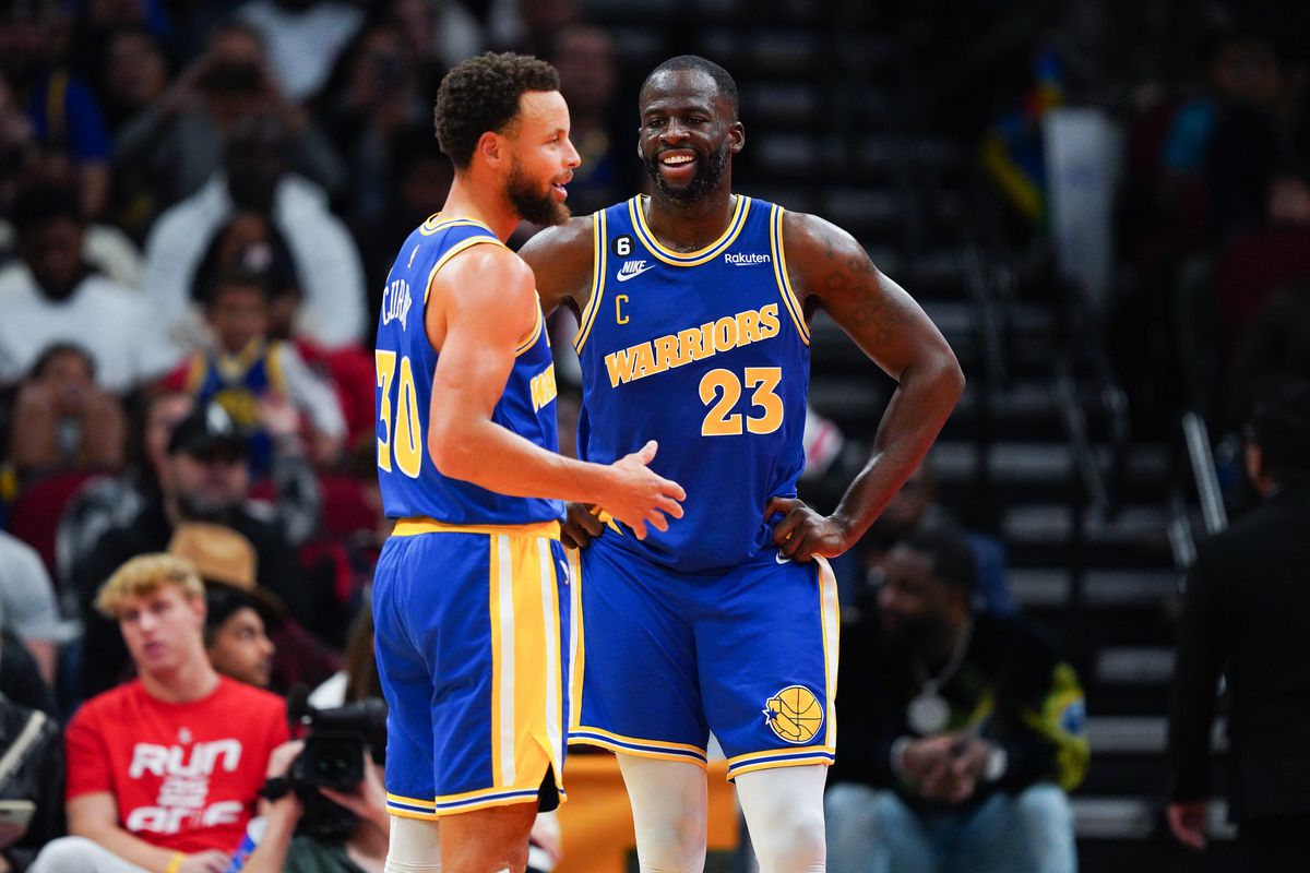Steph Curry and Draymond Green talking on the court