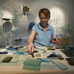 Jodie McRaney Rusho arranges glass tiles in the basement of her home.