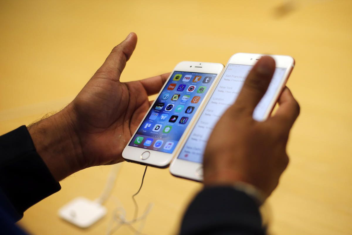 FILE - In this Friday, Sept. 25, 2015, file photo, a customer tries out a new Apple iPhone 6S at an Apple store in Chicago. The FBI now says that it may have a way to crack into an iPhone used by one of the San Bernardino shooters, despite previous claims