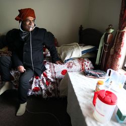 Bhagi Neupane sits on his bed at home in Salt Lake City on Friday, Nov. 6, 2015. Bhagi suffers from asthma and requires oxygen most hours of the day.