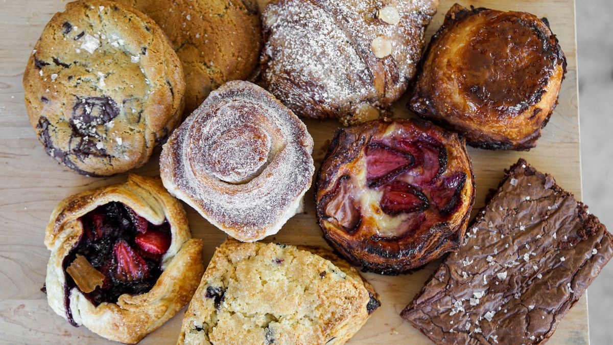 Colorful French-style pastries on a wooden cutting board.
