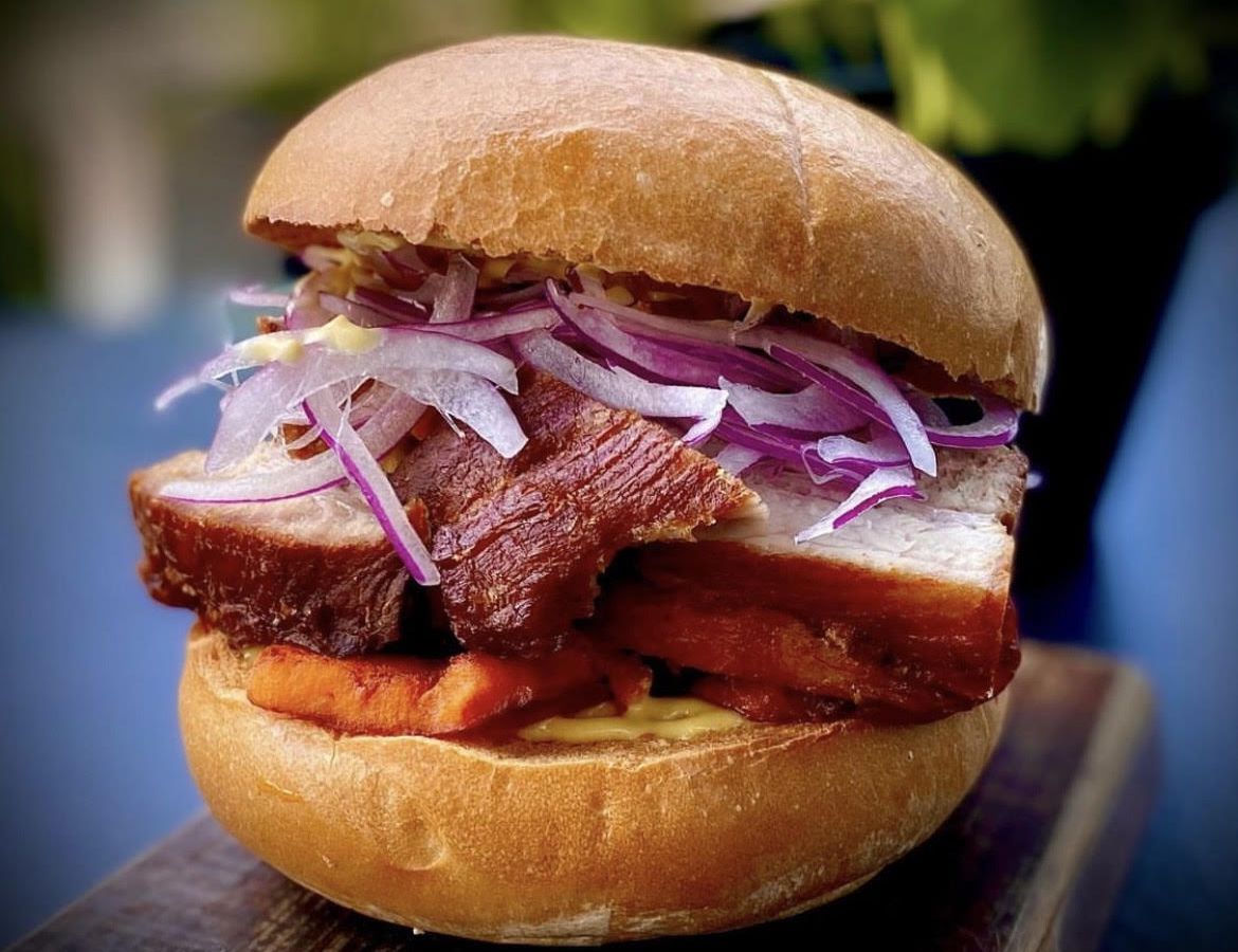 Pacha Nikkei’s pan con chicharron sandwich, which is stuffed with fried pork belly and onions.