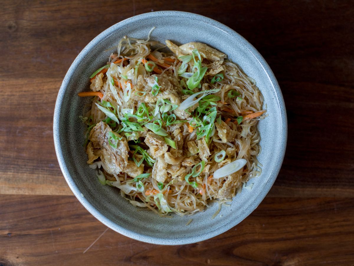 Magna’s Pancit Bihon, a corn starch noodle, comes with chicken skin chicharron, carrots, cabbage, and scallions