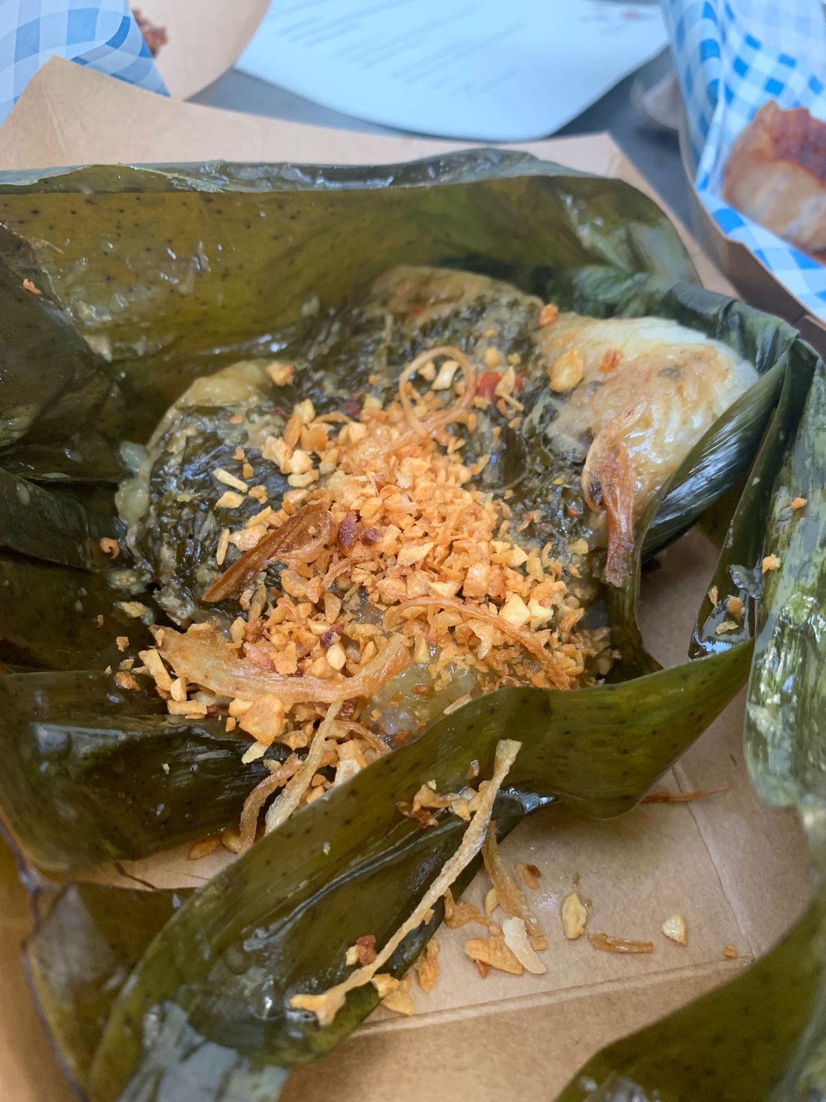 Sticky rice wrapped in a banana leaf, with kale, ginger, and chilli.
