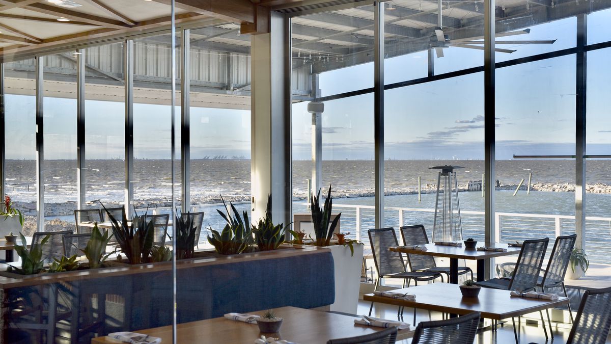 The interior of Pier 6 seafood, overlooking the San Leon waterfront through large windows