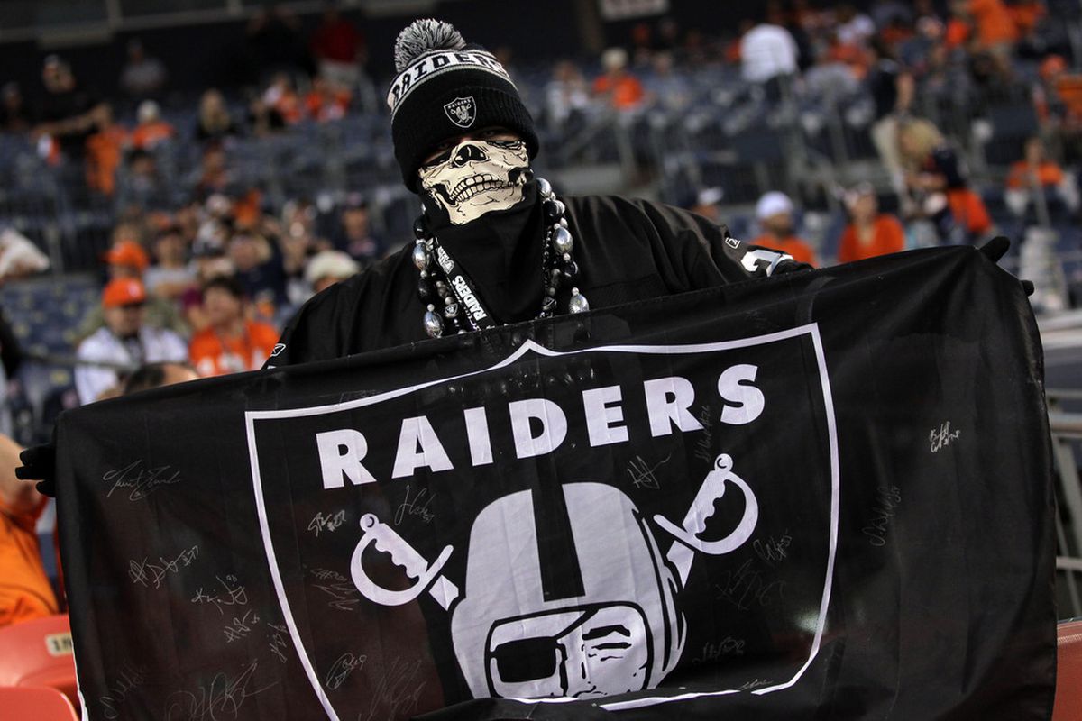 DENVER, CO - SEPTEMBER 12:  An Oakland Raiders fan holds up a flag before the Raiders take on the Denver Broncos at Invesco Field at Mile High on September 12, 2011 in Denver, Colorado.  (Photo by Doug Pensinger/Getty Images)
