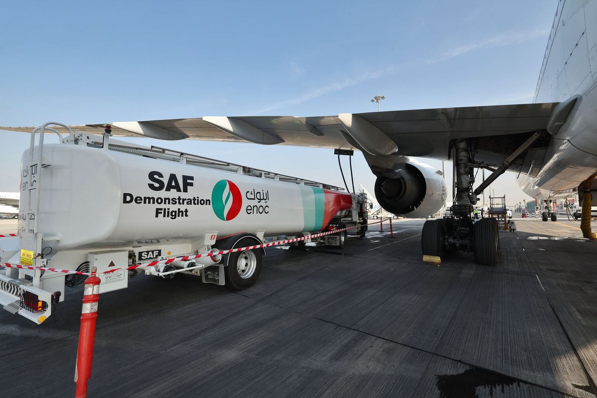 Ground crews prepare an Emirates Boeing 777-300ER aircraft, powering one of its engines with a hundred per cent Sustainable Aviation Fuel (SAF), for a demonstration flight at the Dubai International Airport in Dubai, on January 30, 2023.