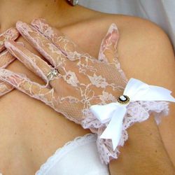<b>4. Sheer Pink Lace Gloves,</b> $38: These delicate and darling pink lace gloves incorporate color and softness into your look. Embellished with ivory satin ribbons and cameo buttons, these lovelies invoke a feeling of whimsy. Available online at 
<a h
