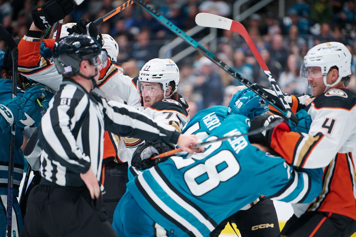 Nov 5, 2022; San Jose, California, USA; linesman James Tobias (61) watches as Anaheim Ducks and San Jose Sharks players scuffle after the whistle during the second period at SAP Center at San Jose.