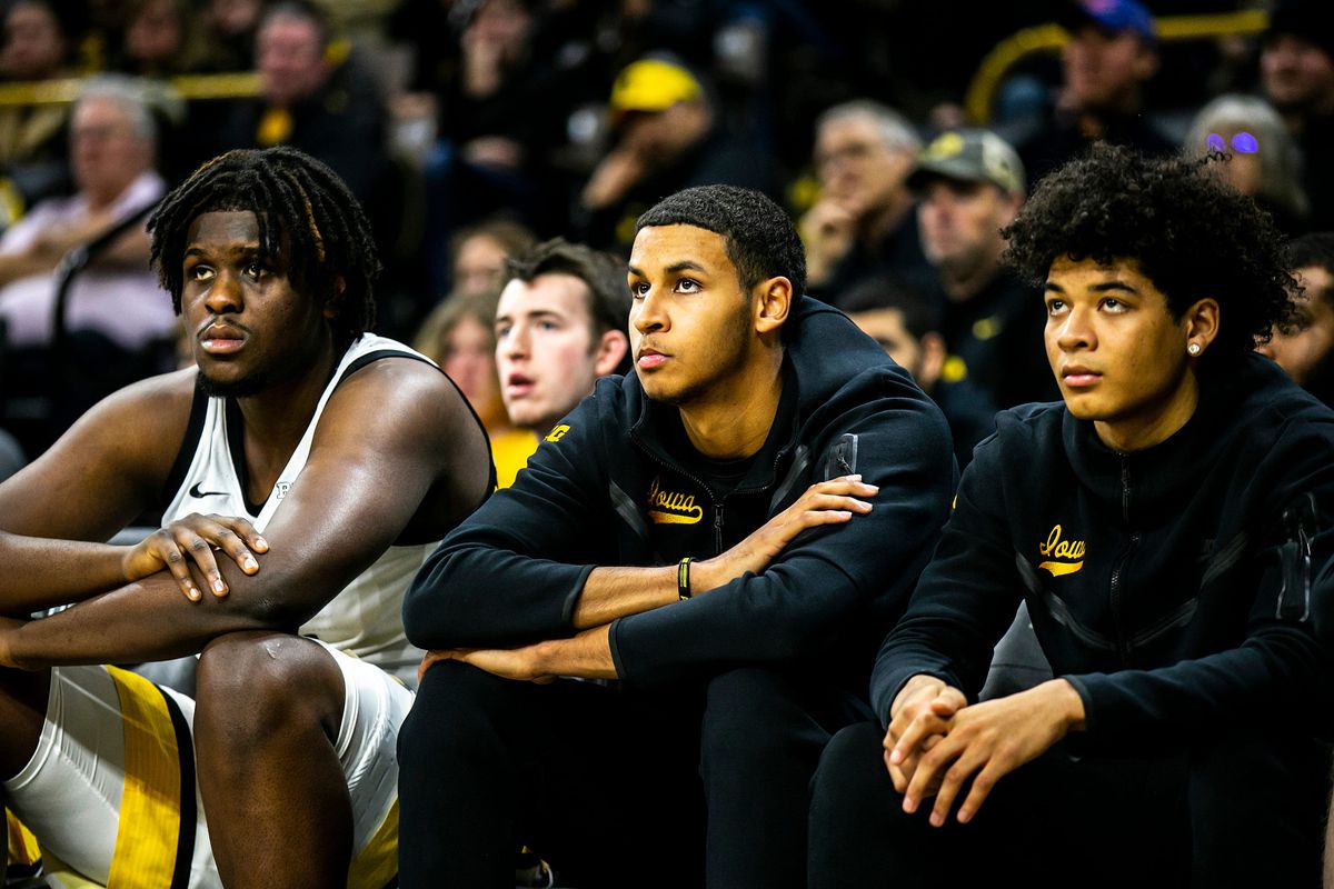 Iowa forwards Josh Ogundele, left, Kris Murray, center, and guard Amarion Nimmers sit on the bench during a NCAA men’s basketball game against Eastern Illinois, Wednesday, Dec. 21, 2022, at Carver-Hawkeye Arena in Iowa City, Iowa.