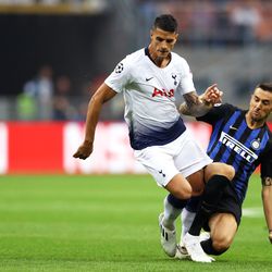 Erik Lamela of Tottenham Hotspur is tackled by Matias Vecino of Inter Milan during the Group B match of the UEFA Champions League between FC Internazionale and Tottenham Hotspur at San Siro Stadium on September 18, 2018 in Milan, Italy.