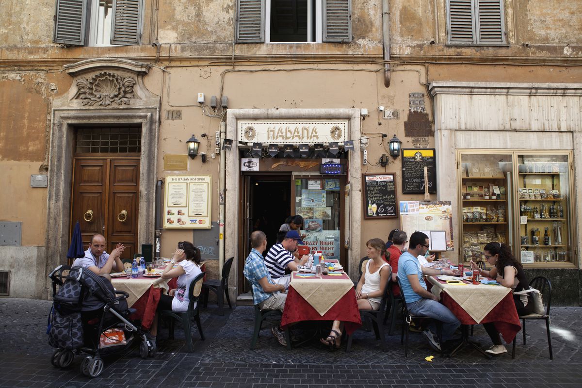 Diners eating al fresco at a restaurant in a back street