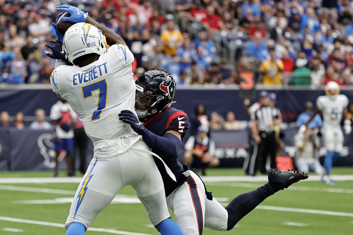 Gerald Everett #7 of the Los Angeles Chargers makes a catch for a touchdown past Jalen Pitre #5 of the Houston Texans in the first quarter at NRG Stadium on October 02, 2022 in Houston, Texas.