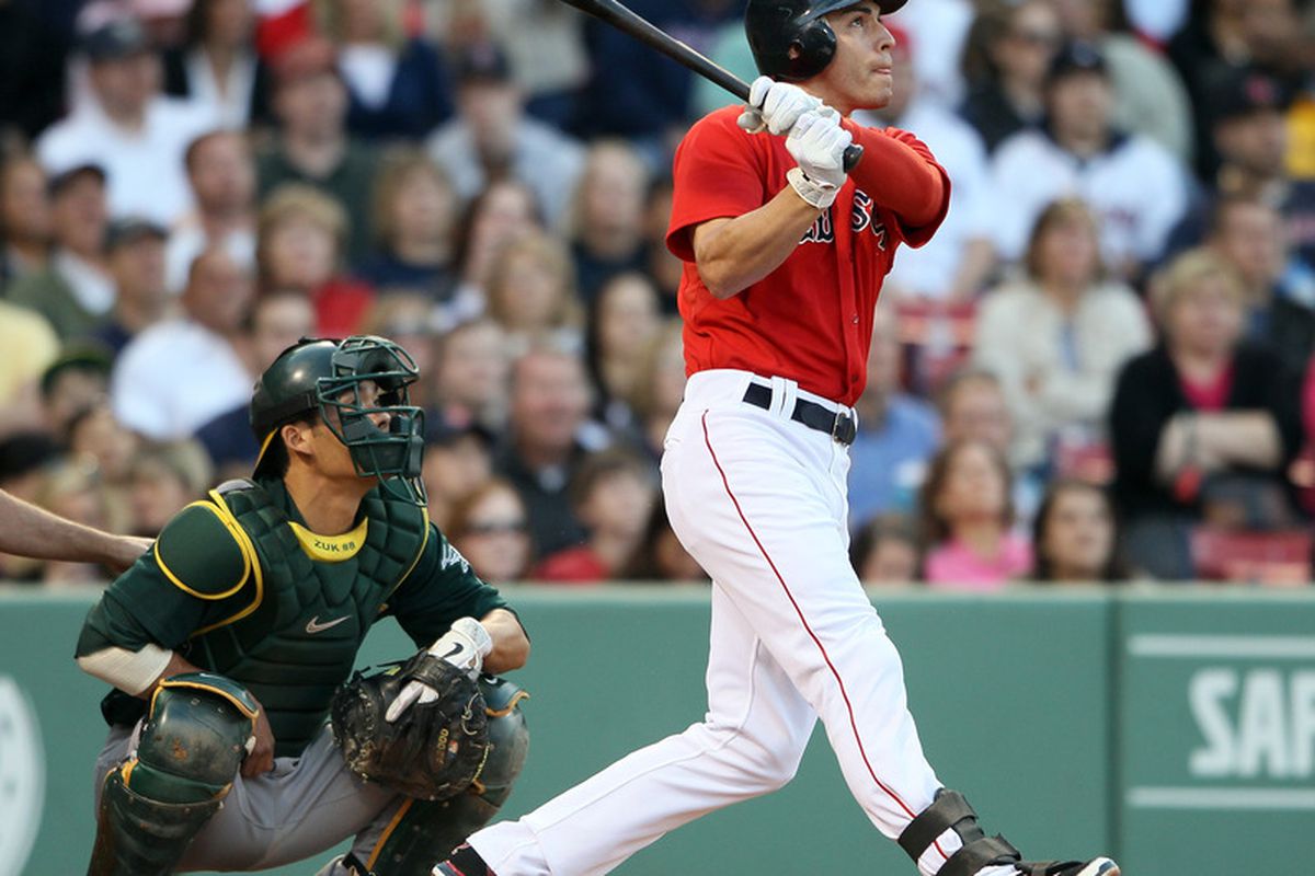BOSTON, MA - JUNE 03: Jacoby Ellsbury #2 of the Boston Red Sox gets a hit in the first inning as Kurt Suzuki #8 of the Oakland Athletics defends on June 3, 2011 at Fenway Park in Boston, Massachusetts.  (Photo by Elsa/Getty Images)