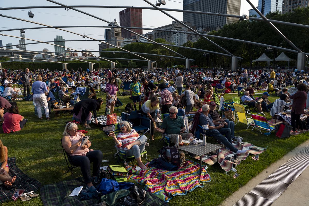Concertgoers gather on the Great Lawn at the Pritzker Pavilion to enjoy music during the Grant Park Music Festival’s 2021 opening night at Millennium Park, on Friday.