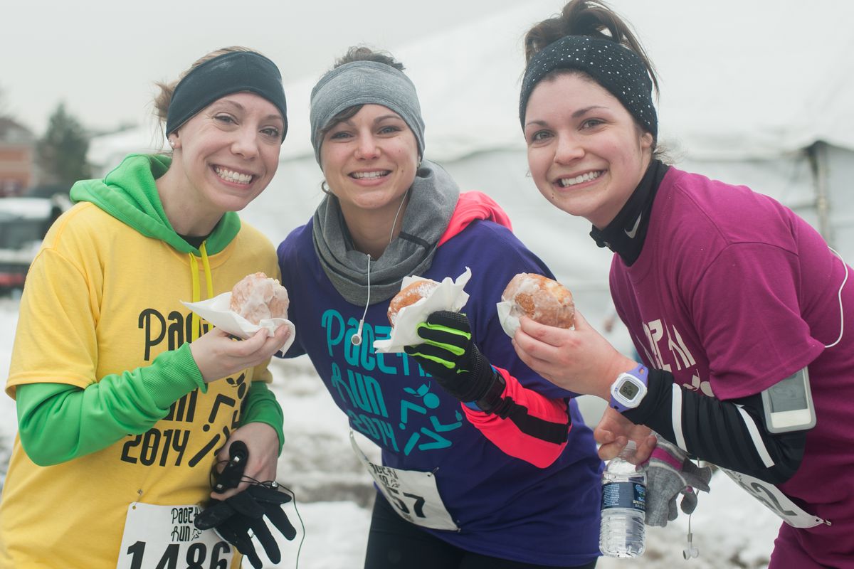 Runners feast on paczki at the finish line in 2014.