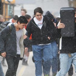 Students fight the wind and blowing snow as they arrive at Farmington Junior High School in Farmington, Tuesday, April 9, 2013.