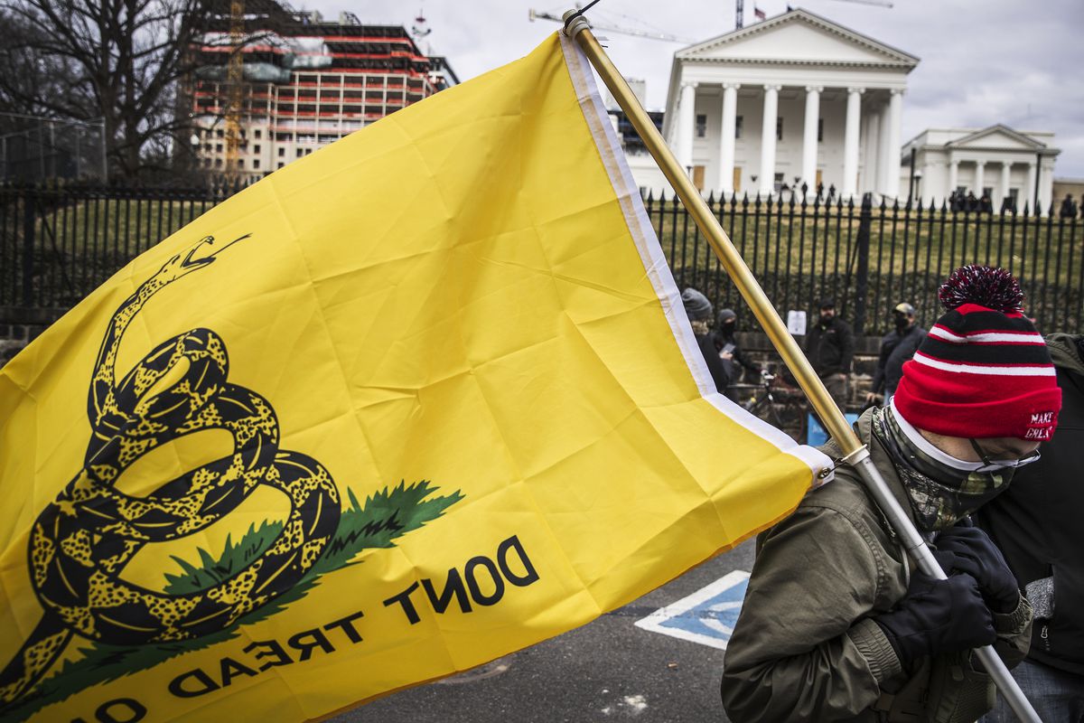 A gun rights advocate holds a “Don’t tread on me” flag during the Virginia Citizens Defense League (VCDL) Lobby Day rally