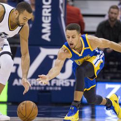 Utah center Rudy Gobert (27) and Golden State guard Stephen Curry (30) reach for the ball during the first half of an NBA basketball game in Salt Lake City on Thursday, Dec. 8, 2016. Golden State defeated Utah with a final score of 106-99.