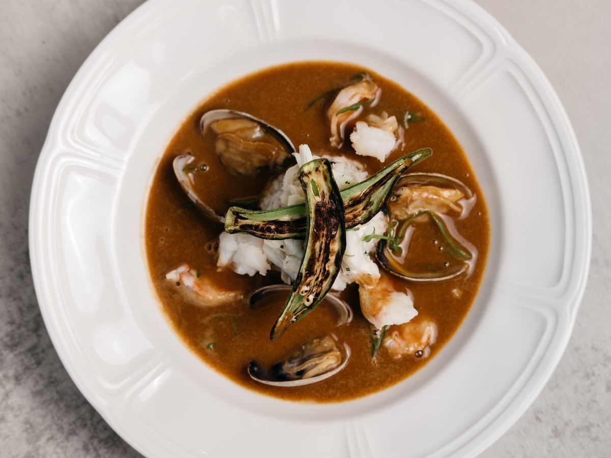 A bowl of gumbo from Navy Blue, served with mussels, shrimp, rice, and a topping of charred oysters.