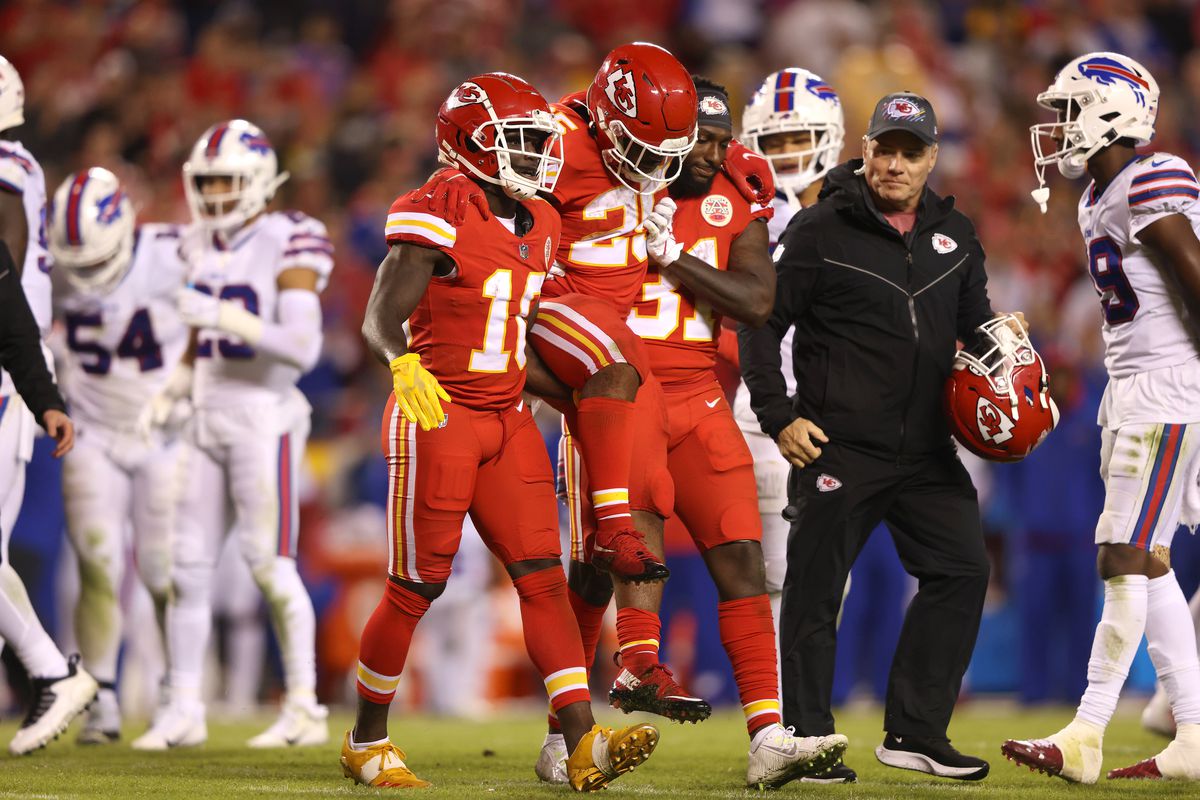 Charvarius Ward #35 and Tyreek Hill #10 help Clyde Edwards-Helaire #25 of the Kansas City Chiefs off the field after he was injured during the second half of a game against the Buffalo Bills at Arrowhead Stadium on October 10, 2021 in Kansas City, Missouri.