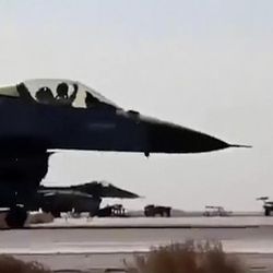In this image made from Wednesday, Feb. 4, 2015, video provided by Jordanian military via Roya TV, an air force pilot raises his arm as he taxis his jet at Mowafak Al-Salti airbase in Azraq, Jordan. The military carried out airstrikes on Islamic State weapons depots and training sites on Thursday and Friday. King Abdullah II has thrust Jordan to the center of the war against the Islamic State group with his pledge of relentless retaliation for the killing of one of his pilots.